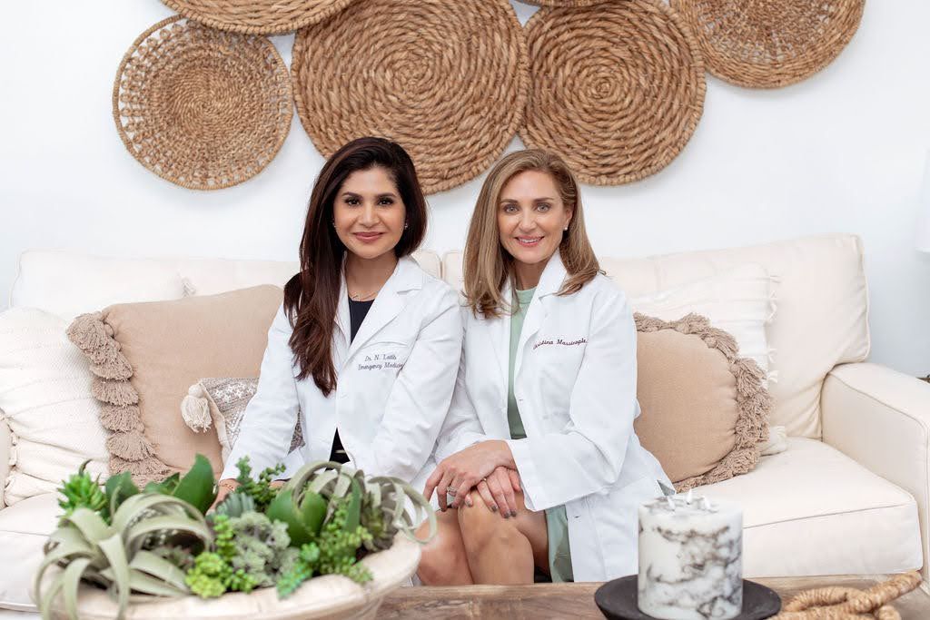 Dr Nashat & Dr Christina on a white sofa